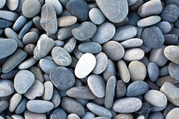 Fototapeta na wymiar Smooth round pebbles sea texture background. Summer day.
