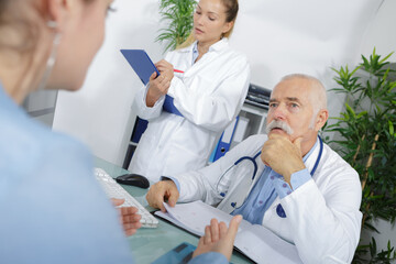 female patient consulting senior doctor