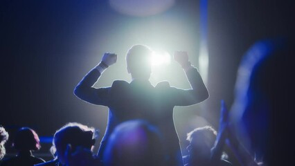 Young Excited Man Ecstatic About Winning the Coveted Business Person of the Year Award. Man Jumping After Winning the Event Category. Handsome Specialist Celebrating and Cheering a Colleague on Stage.