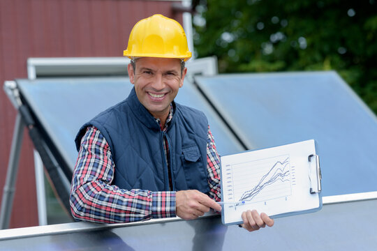 worker installing solar panels outdoors