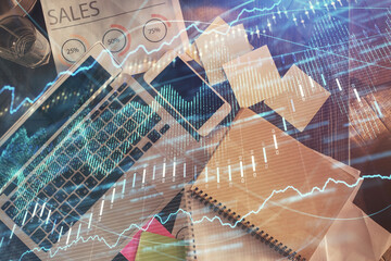 Financial market graph and top view computer on the desktop background. Multi exposure. Investment concept.