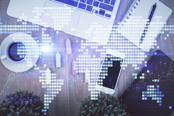 Double exposure of business theme hologram over desktop with phone. Top view. Mobile international trade connection concept.