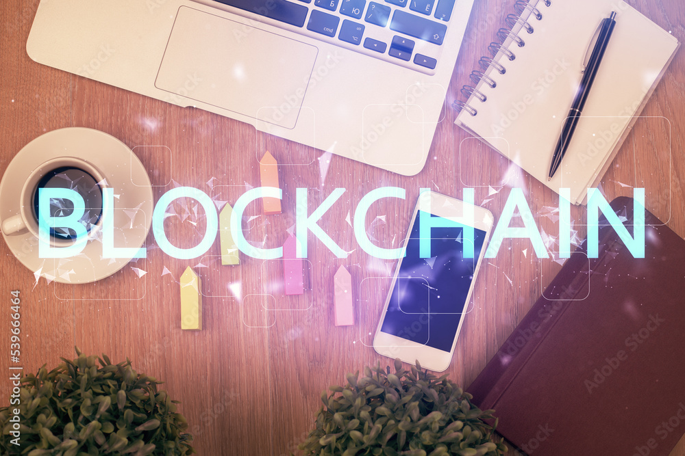 Poster Double exposure of blockchain theme hologram over table with phone. Top view. Crypto technology concept.