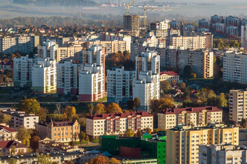 Fototapeta na wymiar aerial panoramic view from height of a multi-storey residential complex and urban development in autumn day