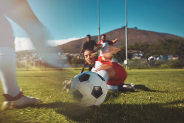 Soccer, ball and slide challenge in game with men team on a grass field with sport man together....