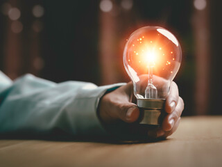 Businesswoman holding a light bulb, Creative new idea. Innovation, brainstorming, solution and...