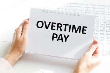 Financial concept about OVERTIME PAY with sign on the sheet.