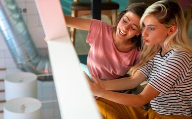 Group of happy women friends having fun together. People technology social media concept.