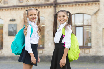 two teen schoolgirls together outdoor. school day