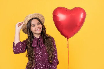 smiling teen girl with red heart balloon on yellow background