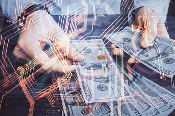 Multi exposure of Tech drawing hologram and USA dollars bills and man hands. Technology concept.
