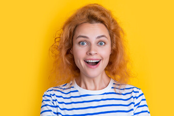 amazed redhead woman face isolated on yellow background. face of young redhead woman