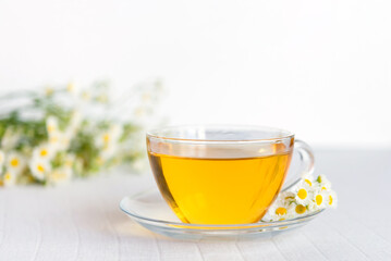 cup of herbal tea with chamomile flowers	