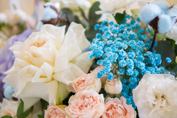 a bouquet of flowers in delicate shades of pink, purple, beige and blue