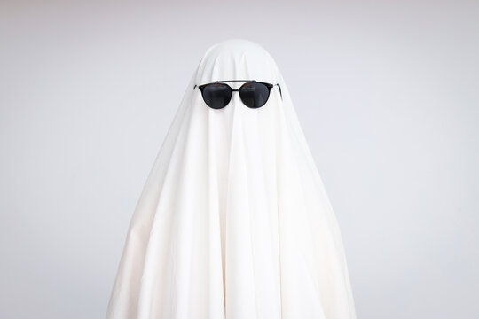 Concept Of Halloween, Ghost With Sunglasses On Light Background