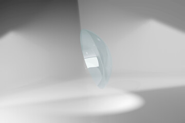 Contact lens floating in white room. Digitally generated