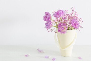 bouquet of pink tulips and gypsophila on white table