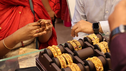Bangalore, India 4th May 2022: Indian customer in a jewellery exhibition buying gold on the...