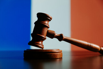 Justice and court concept in French Republic France. Judge gavel close-up on a flag background