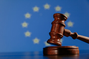 Flag of European Union and wooden judge gavel, concept picture about law and justice