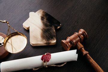 Burnt house, handcuffs and gavel. Crime and judgement concept