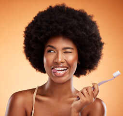 Black woman, toothbrush and for dental wellness for teeth whitening, protection and oral hygiene on orange background. Afro, healthy and smile of a comic lady posing for mouth cleaning and beauty