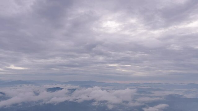 Time lapse of white morning clouds and fogs moving across mountain landscape of Nan province in northern Thailand