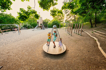 Three kids rides on the playground. Centrifuge, swing for children.