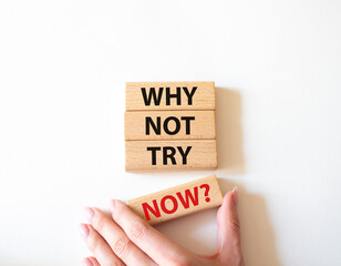 Why not try symbol. Concept words Why not try on wooden blocks. Beautiful white background. Businessman hand. Business and Why not try concept. Copy space.