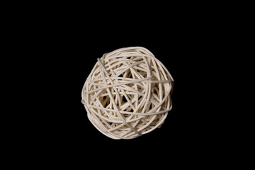 a ball woven from a wooden vine of bamboo on a black background - Powered by Adobe