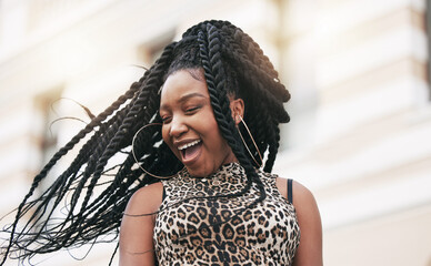 Hair, freedom and fashion with a fun black woman in the city on a summer day feeling cheerful or...