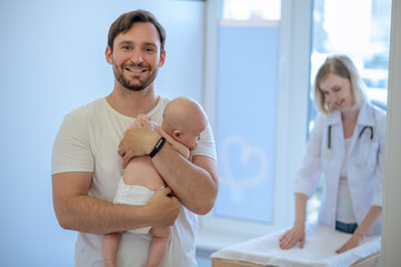Happy parent posing for the camera after the pediatric consultation