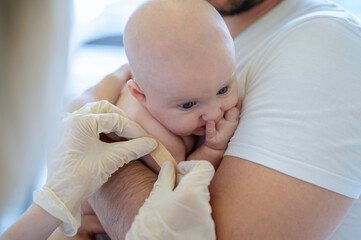 Pediatric doctor performing a medical procedure on the newborn patient