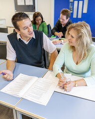 Adult Education: Teaching Advice. A teacher providing some individual tuition to a mature student. From a series of related images on the subject.