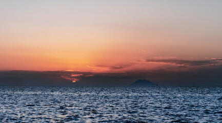 Stromboli volcano smoke and sunset over Tyrrhenian, Mediterranean Sea.  View from Coast of Gods,...
