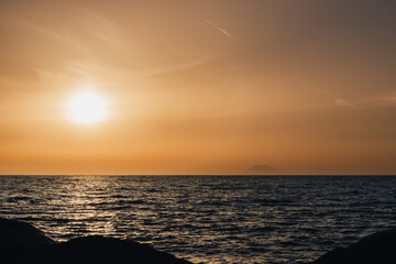 Stromboli volcano smoke and sunset over Tyrrhenian, Mediterranean Sea.  View from Coast of Gods, Calabria, southern Italy.