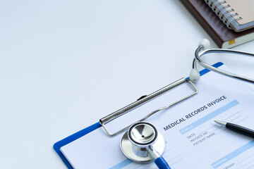 Stethoscope with medical records invoice. on white background.