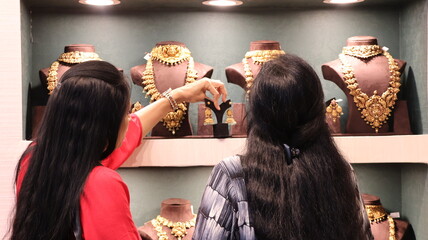 Bangalore, India 4th May 2022: Indian customer in a jewellery exhibition buying gold on the...
