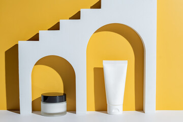 Geometric shapes for skin care cosmetics presentation. Archs stand on a yellow background....