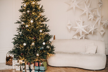 Christmas background with Christmas tree, sofa, fireplace and gifts.
