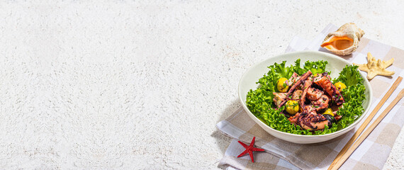 Octopus salad with lettuce, olives and spices in a bowl. Fresh and healthy seafood, marine decor