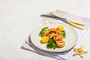 Grilled shrimp salad with lettuce, tomato cherries and spices on a plate. Fresh and healthy seafood