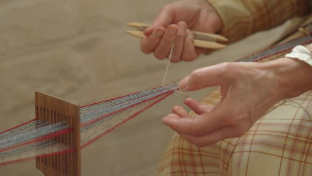 Elderly Scandinavian Woman Inkle Loom Weaving At a Castle - Static Close Up