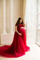 Fototapeta premium Pregnant woman at red dress