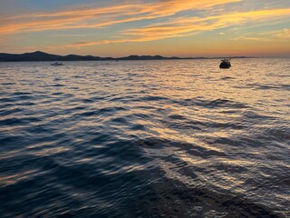 Fototapeta na wymiar Beautiful orange sunset at the sea, natural colors, seascape background