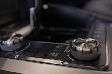 Fototapeta na wymiar Luxury car interior details. Middle console with gearbox controls.