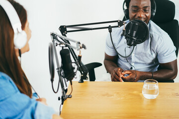 Multiracial hosts streaming podcast together at home studio