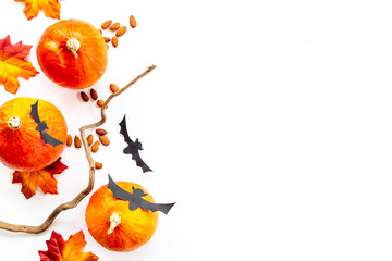 Flat lay of autumn fall iteams with pumpkins and dry leaves