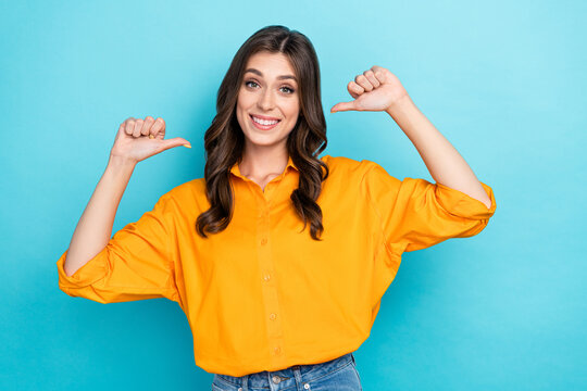 Photo of gorgeous satisfied girl point thumb fingers self herself toothy smile isolated on blue color background