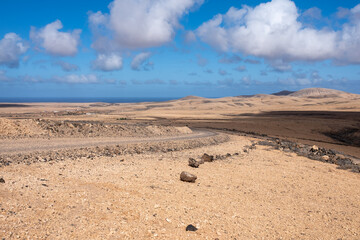 Fototapeta na wymiar Spectacular landscape and deserted roads of volcanic Fuerteventura island, Canary islands